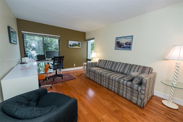 6619 Burning Wood Dr Unit 274, Boca Raton, FL 33433 - living area featuring wood finished floors, healthy amount of natural light, a desk, and baseboards