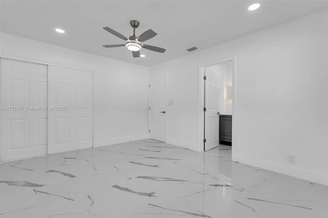 unfurnished bedroom featuring connected bathroom, ceiling fan, and a closet