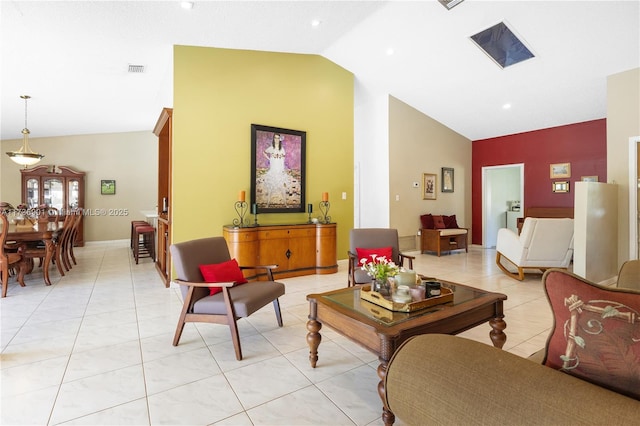 living room featuring light tile patterned floors and high vaulted ceiling