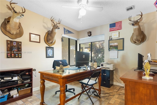 office space with ceiling fan and a textured ceiling