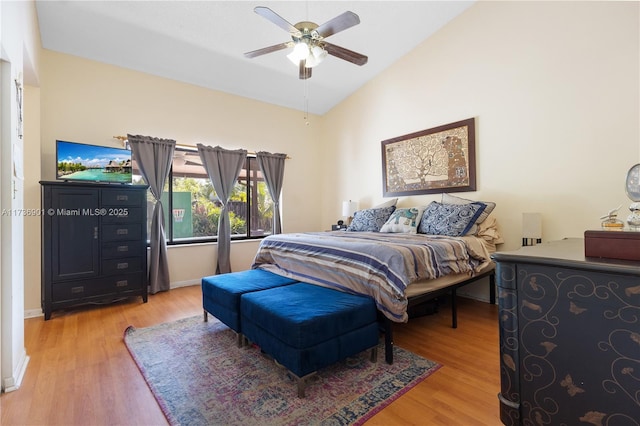 bedroom with ceiling fan, lofted ceiling, and wood-type flooring