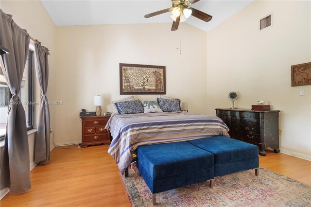 bedroom with light hardwood / wood-style flooring, ceiling fan, and vaulted ceiling