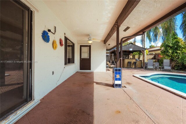 view of swimming pool featuring a bar and a patio area