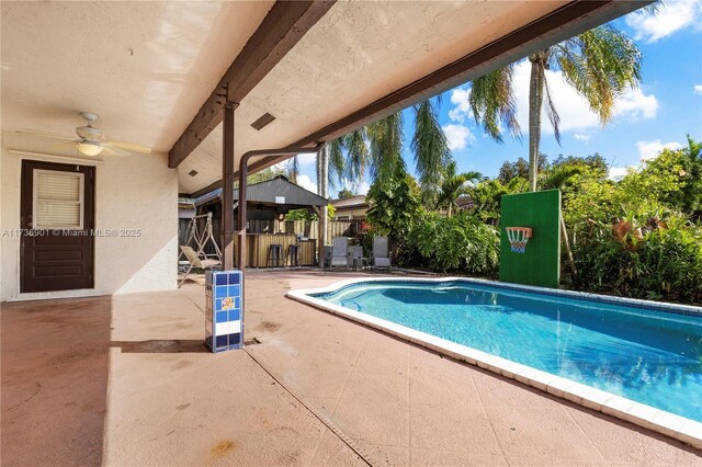 view of pool featuring a patio, exterior bar, and ceiling fan