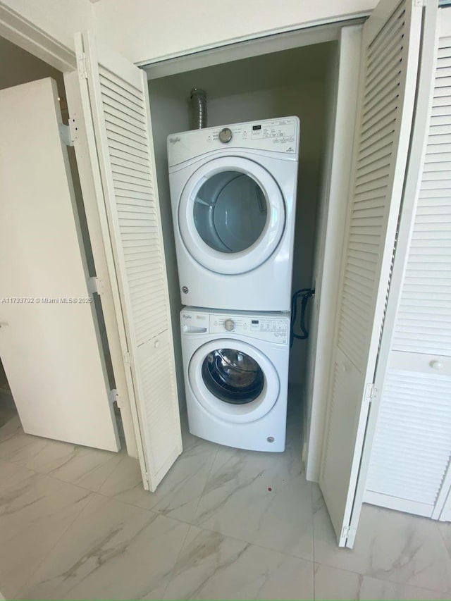 laundry area with stacked washer / dryer