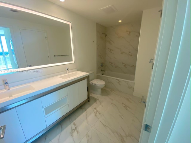 full bathroom featuring vanity, toilet, and tiled shower / bath