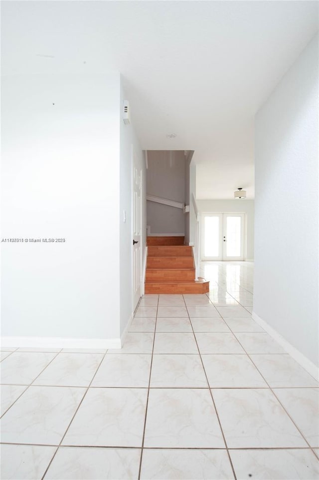 hall with light tile patterned flooring