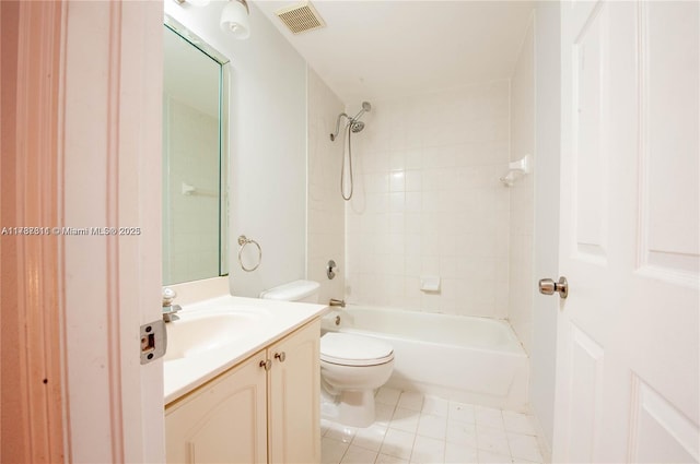 full bathroom featuring vanity, tiled shower / bath combo, tile patterned floors, and toilet