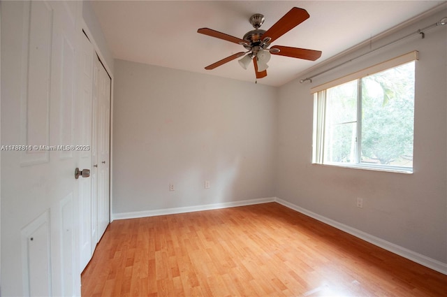 empty room featuring ceiling fan and light wood-type flooring