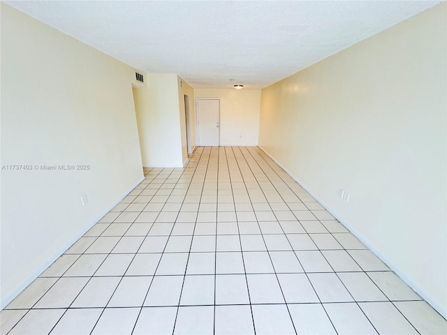 empty room with light tile patterned floors