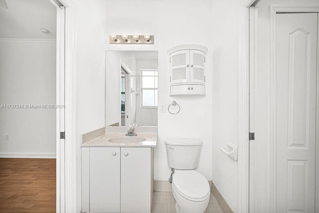 bathroom with vanity, wood-type flooring, and toilet