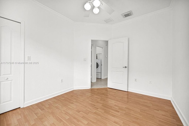 unfurnished room with ceiling fan, ornamental molding, washer / dryer, and light wood-type flooring