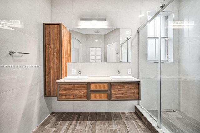 bathroom with vanity and a shower with shower door