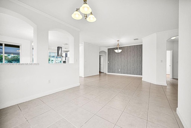 tiled spare room with crown molding