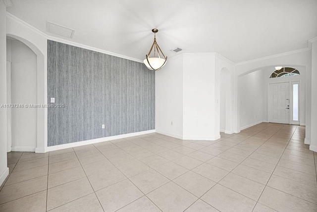 spare room with light tile patterned floors and crown molding