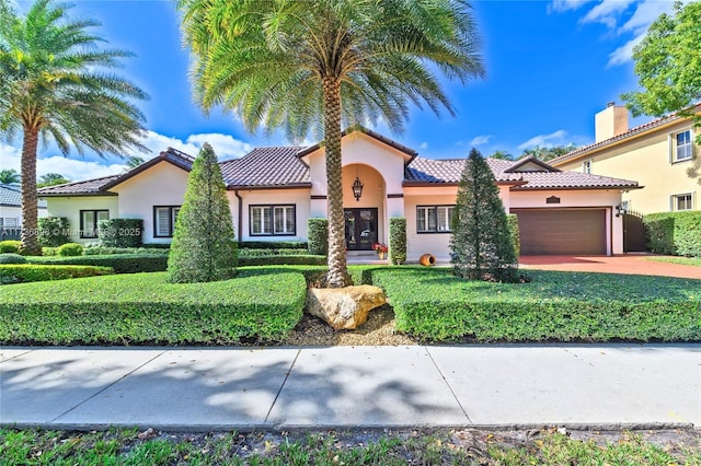 mediterranean / spanish-style home with a garage