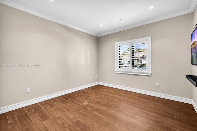 empty room with hardwood / wood-style flooring and ornamental molding