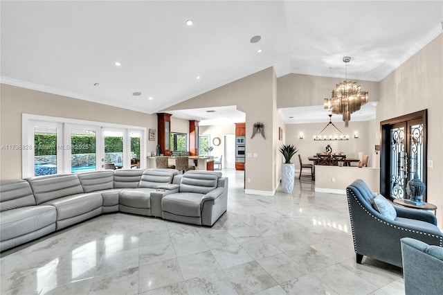 living room featuring ornate columns, high vaulted ceiling, a chandelier, ornamental molding, and french doors