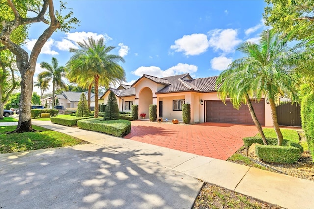 mediterranean / spanish house featuring a garage