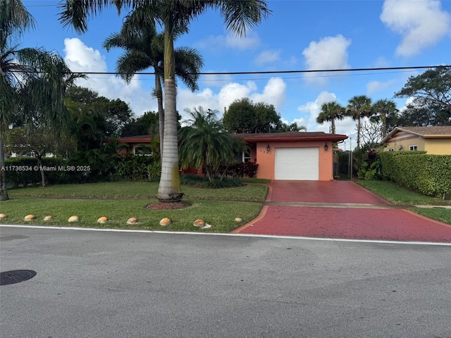 view of front of home featuring a garage and a front lawn