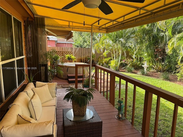 deck featuring a hot tub, outdoor lounge area, and ceiling fan