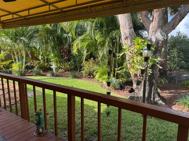 wooden deck featuring a yard