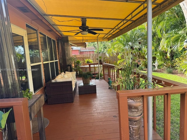 wooden deck featuring outdoor lounge area and ceiling fan