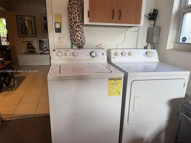 washroom with cabinets, separate washer and dryer, a healthy amount of sunlight, and tile patterned flooring