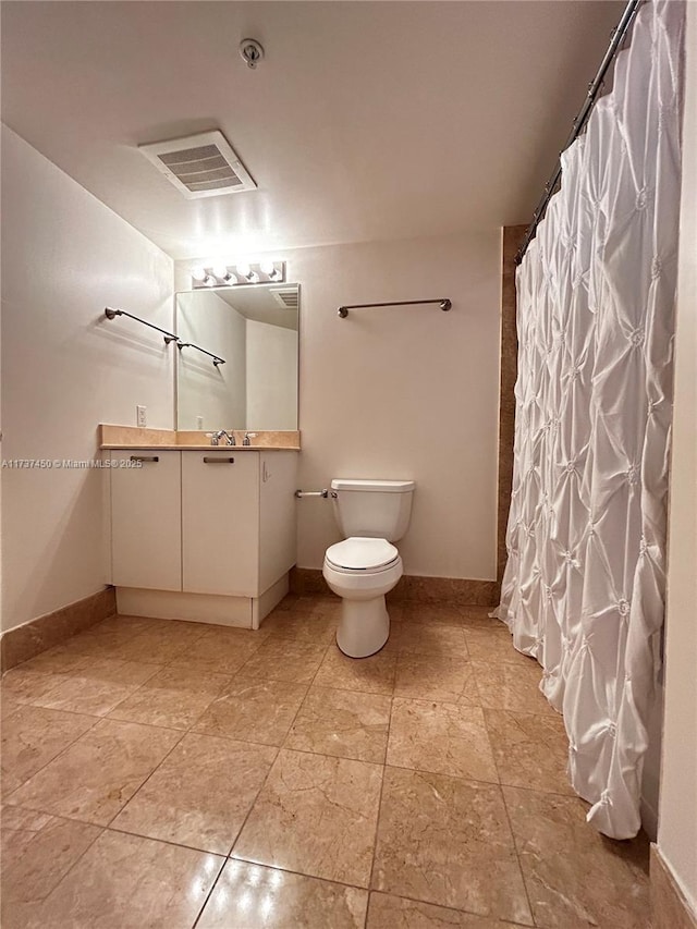 bathroom with toilet, baseboards, visible vents, and vanity