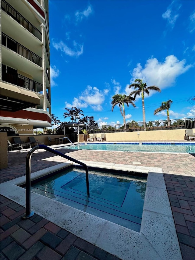 pool featuring a patio area and fence