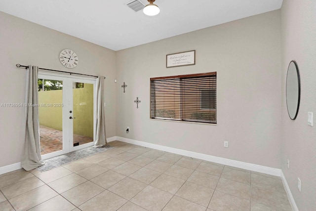 tiled empty room with french doors