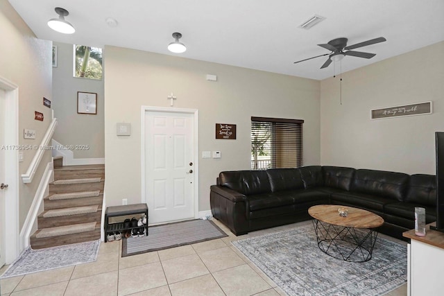 tiled living room featuring ceiling fan