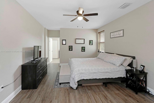 bedroom with dark hardwood / wood-style floors and ceiling fan