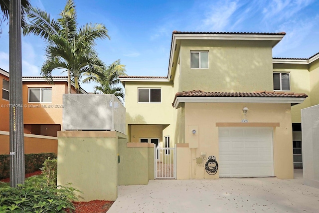 mediterranean / spanish-style house with a garage