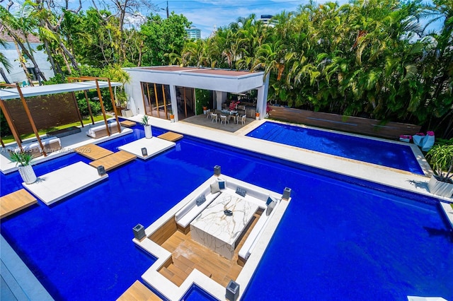 view of pool with a patio area and a jacuzzi