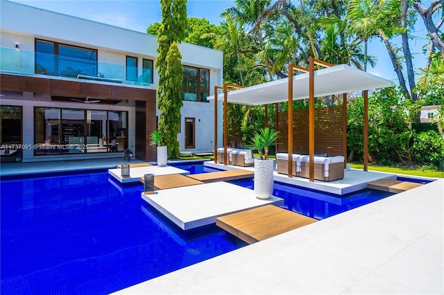 view of swimming pool with an outdoor living space and a patio area