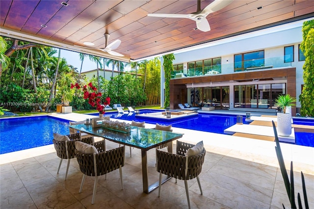 view of swimming pool with a patio, ceiling fan, and a jacuzzi