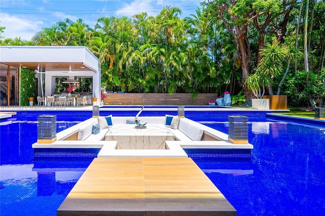 view of pool with a patio and ceiling fan