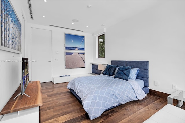 bedroom featuring dark hardwood / wood-style flooring