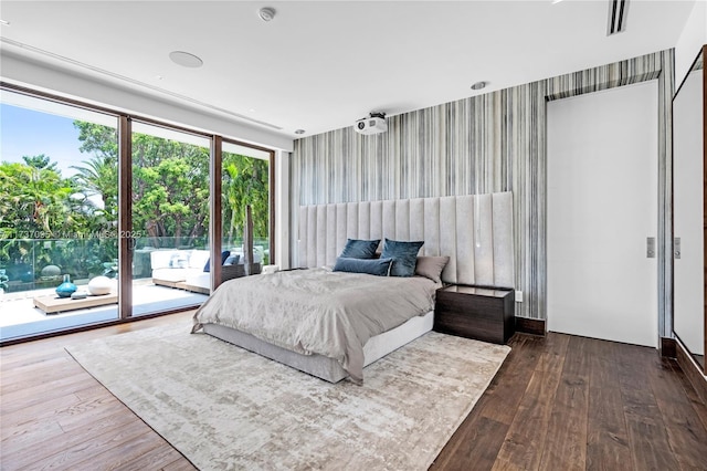 bedroom featuring hardwood / wood-style flooring and access to exterior