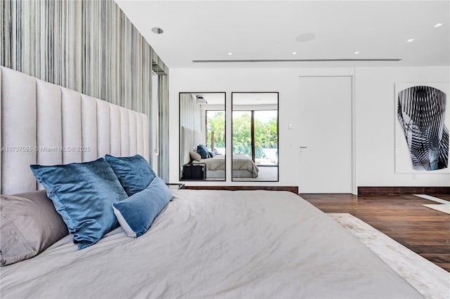 bedroom with dark hardwood / wood-style flooring and access to exterior