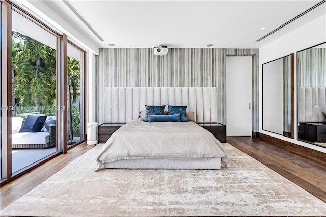 bedroom featuring dark wood-type flooring and access to outside