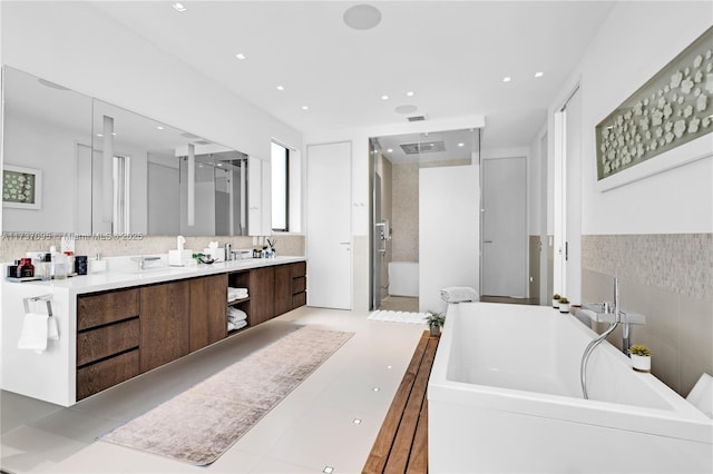 bathroom featuring tile patterned floors, vanity, and shower with separate bathtub