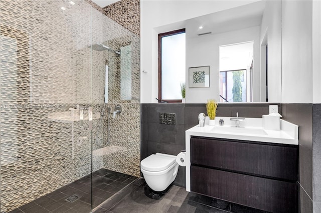 bathroom featuring vanity, toilet, an enclosed shower, and tile walls