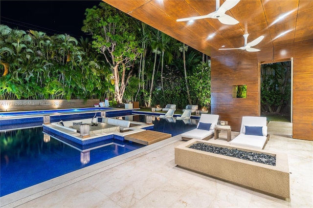 view of swimming pool featuring a patio, ceiling fan, and a fire pit