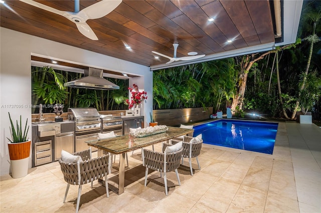 view of swimming pool with sink, a patio area, ceiling fan, and exterior kitchen