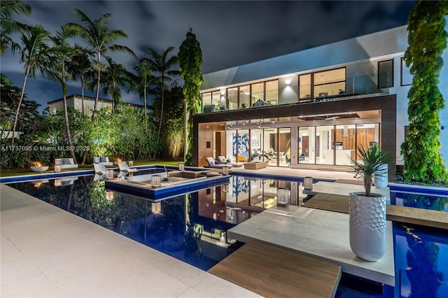 view of swimming pool featuring a jacuzzi and a patio area