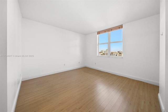 spare room with light hardwood / wood-style flooring