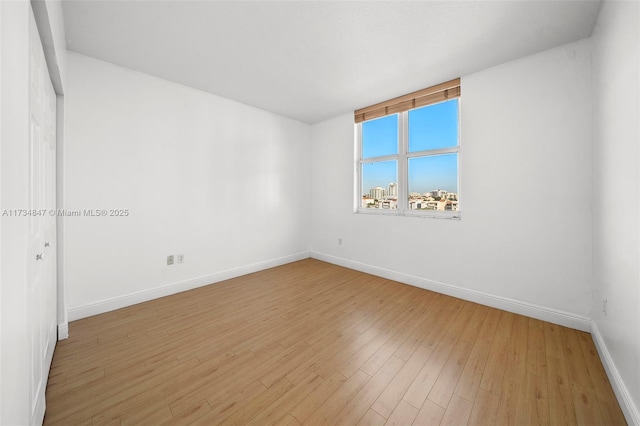 spare room featuring light hardwood / wood-style flooring