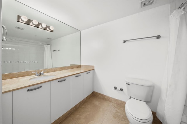 bathroom featuring vanity, toilet, and tile patterned flooring